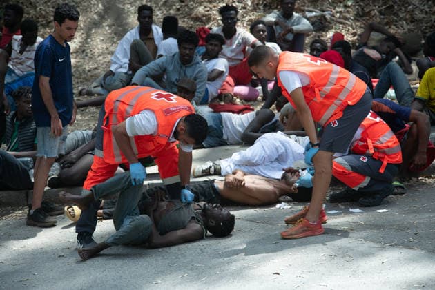 August 1, 2026, Ceuta, Ceuta, Spain: Red Cross members attend to migrants near the Temporary Stay Centre for Immigrants Ceuta Spain - ZUMAd308 20260801_zsp_d308_069 Copyright: xJuanxCarlosxLucasx