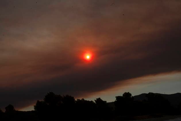 Wildfire Smoke and Strong Winds Hit Corinthia Coast The sun shines through a sky filled with wildfire smoke in Almiri, Corinthia, Greece on August 1, 2026. Smoke from a wildfire burning in the neighboring regional unit of Viotia spreads across the Saronic Gulf as firefighters continue efforts to contain the blaze. Almiri Corinthia Greece Copyright: xElvisxTakahashixMantellox