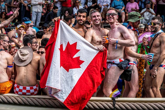 August 1, 2026, Amsterdam, North Holland, Netherlands: A Canal Parade participant displays a Canadian flag. August 1, 2026, Amsterdam, the Netherlands. Hundreds of thousands of spectators joined the 30th edition of the Pride Canal Parade, the highlight of WorldPride Amsterdam 2026. This yearÃ¢â‚¬â ¢s parade also included the WorldPride Stadium grandstand, with seating for approximately 10,000 people to watch as floats pass. Amsterdam Netherlands - ZUMAp202 20260801_zip_p202_047 Copyright: xJamesxPetermeierx