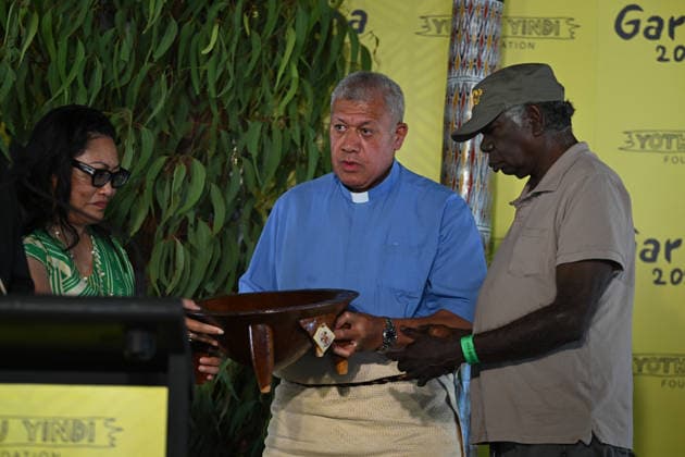 GARMA FESTIVAL, Reverend Alimoni Taumoepeau of Tonga and Australia (centre) presents a gift to Djawa YunupiÅ‹u, Chairman, Yothu Yindi Foundation (right) during the 26th annual Garma Festival in Gulkula, Northern Territory, Saturday, August 1, 2026. The Garma Festival takes place on the remote northeast Arnhem Land, celebrating Yolngu culture and customs in a four-day event hosted by the Yothu Yindi Foundation. ( NO ARCHIVING - VISUALS FROM THE YYF GARMA 26TH ANNIVERSARY ARE STRICTLY FOR NEWS AND CURRENT AFFAIRS COVERAGE ONLY. VISUALS MUST NOT BE USED FOR PROMOTIONAL, ADVERTISING, COMMERCIAL, FUNDRAISING OR ANY OTHER PURPOSE Gulkula Ceremonial Site Northern Territory Australia  Copyright: xJamesxRossx 20260802161983633300