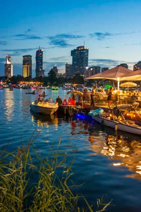 Lichterlfest (Lichterfest, Festival of Lights) at oxbow lake Alte Donau (Old Danube), illuminated boats, high-rises of Donaucity, floating restaurant Strandcafe Vienna 22. Donaustadt Wien Austria