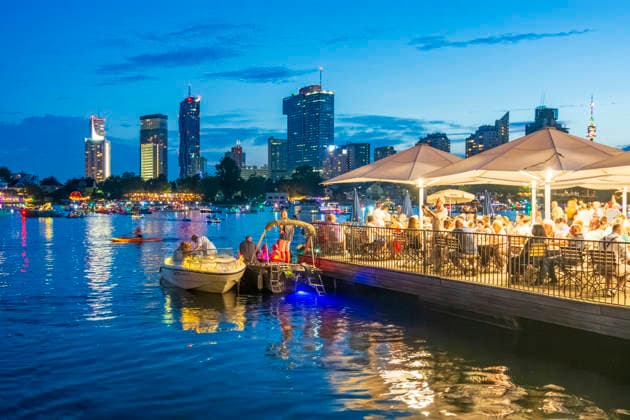 Lichterlfest (Lichterfest, Festival of Lights) at oxbow lake Alte Donau (Old Danube), illuminated boats, high-rises of Donaucity, floating restaurant Strandcafe Vienna 22. Donaustadt Wien Austria