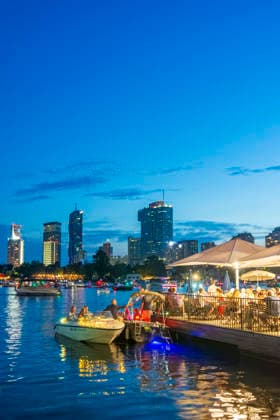 Lichterlfest (Lichterfest, Festival of Lights) at oxbow lake Alte Donau (Old Danube), illuminated boats, high-rises of Donaucity, floating restaurant Strandcafe Vienna 22. Donaustadt Wien Austria