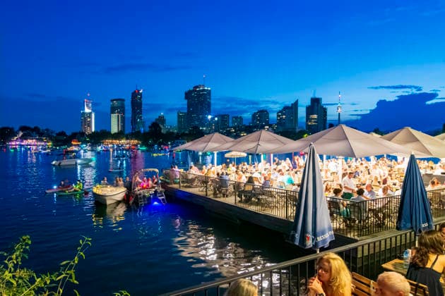 Lichterlfest (Lichterfest, Festival of Lights) at oxbow lake Alte Donau (Old Danube), illuminated boats, high-rises of Donaucity, floating restaurant Strandcafe Vienna 22. Donaustadt Wien Austria