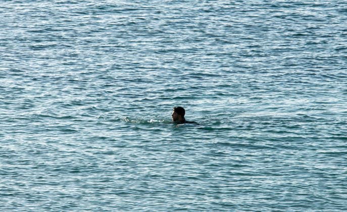 August 2, 2026, Ceuta, Madrid, Spain: A migrant attempts to swim across the border under the watchful eye of the Spanish Civil Guard at El Tarajal beach in Ceuta, Spain, August 2, 2026. Ceuta Spain  - ZUMAd308 20260802_zsp_d308_001 Copyright: xJuanxCarlosxLucasx