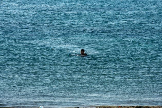 August 2, 2026, Ceuta, Madrid, Spain: A migrant attempts to swim across the border under the watchful eye of the Spanish Civil Guard at El Tarajal beach in Ceuta, Spain, August 2, 2026. Ceuta Spain - ZUMAd308 20260802_zsp_d308_003 Copyright: xJuanxCarlosxLucasx