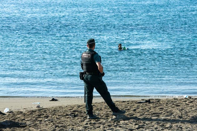 August 2, 2026, Ceuta, Madrid, Spain: A migrant attempts to swim across the border under the watchful eye of the Spanish Civil Guard at El Tarajal beach in Ceuta, Spain, August 2, 2026. Ceuta Spain  - ZUMAd308 20260802_zsp_d308_004 Copyright: xJuanxCarlosxLucasx
