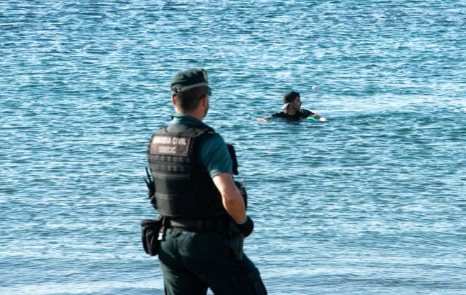 August 2, 2026, Ceuta, Madrid, Spain: A migrant attempts to swim across the border under the watchful eye of the Spanish Civil Guard at El Tarajal beach in Ceuta, Spain, August 2, 2026. Ceuta Spain  - ZUMAd308 20260802_zsp_d308_005 Copyright: xJuanxCarlosxLucasx