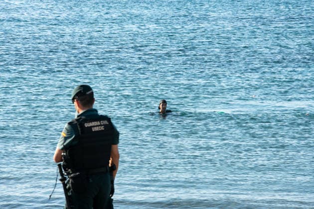 August 2, 2026, Ceuta, Madrid, Spain: A migrant attempts to swim across the border under the watchful eye of the Spanish Civil Guard at El Tarajal beach in Ceuta, Spain, August 2, 2026. Ceuta Spain  - ZUMAd308 20260802_zsp_d308_006 Copyright: xJuanxCarlosxLucasx