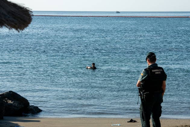 August 2, 2026, Ceuta, Madrid, Spain: A migrant attempts to swim across the border under the watchful eye of the Spanish Civil Guard at El Tarajal beach in Ceuta, Spain, August 2, 2026. Ceuta Spain  - ZUMAd308 20260802_zsp_d308_007 Copyright: xJuanxCarlosxLucasx