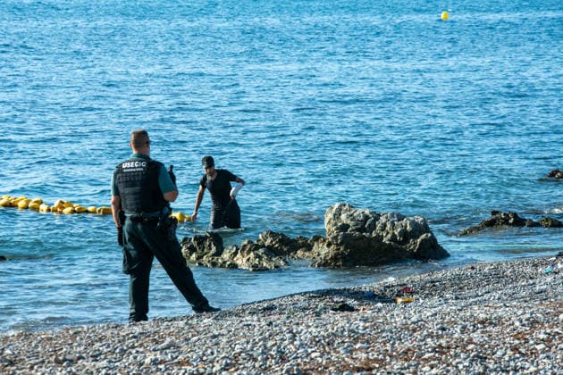 August 2, 2026, Ceuta, Madrid, Spain: A migrant attempts to swim across the border under the watchful eye of the Spanish Civil Guard at El Tarajal beach in Ceuta, Spain, August 2, 2026. Ceuta Spain - ZUMAd308 20260802_zsp_d308_020 Copyright: xJuanxCarlosxLucasx