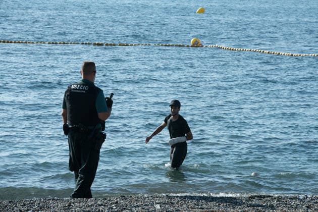 August 2, 2026, Ceuta, Madrid, Spain: A migrant attempts to swim across the border under the watchful eye of the Spanish Civil Guard at El Tarajal beach in Ceuta, Spain, August 2, 2026. Ceuta Spain - ZUMAd308 20260802_zsp_d308_021 Copyright: xJuanxCarlosxLucasx