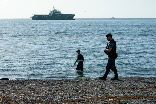 August 2, 2026, Ceuta, Madrid, Spain: A migrant attempts to swim across the border under the watchful eye of the Spanish Civil Guard at El Tarajal beach in Ceuta, Spain, August 2, 2026. Ceuta Spain  - ZUMAd308 20260802_zsp_d308_023 Copyright: xJuanxCarlosxLucasx