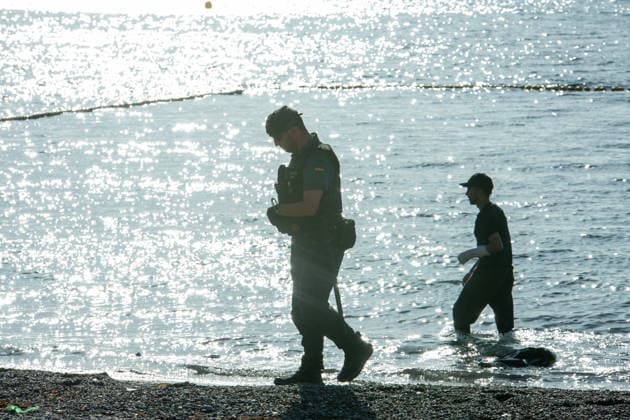 August 2, 2026, Ceuta, Madrid, Spain: A migrant attempts to swim across the border under the watchful eye of the Spanish Civil Guard at El Tarajal beach in Ceuta, Spain, August 2, 2026. Ceuta Spain - ZUMAd308 20260802_zsp_d308_026 Copyright: xJuanxCarlosxLucasx