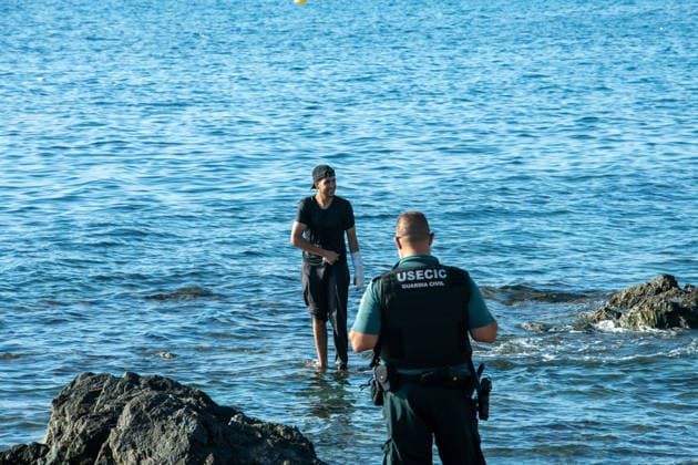August 2, 2026, Ceuta, Madrid, Spain: A migrant attempts to swim across the border under the watchful eye of the Spanish Civil Guard at El Tarajal beach in Ceuta, Spain, August 2, 2026. Ceuta Spain - ZUMAd308 20260802_zsp_d308_032 Copyright: xJuanxCarlosxLucasx