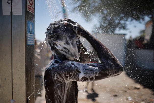 The barriers installed by the government in Ceuta are now fully operational. A person is showering at the public beach shower on August 2, 2026, in Ceuta, Spain. The Tarajal border has remained calm despite a small group of people attempting to swim across; however, they were intercepted by the army. Although more than 48,000 migrants who had entered irregularly last Thursday have already left Ceuta, an unknown number of people who have refused to return remain in the city. AUGUST 2, 2026 PIXELATED MIGRATION CRISIS Jesú Ceuta Ceuta, Spain  Copyright: xJesusxTorresx 7699307