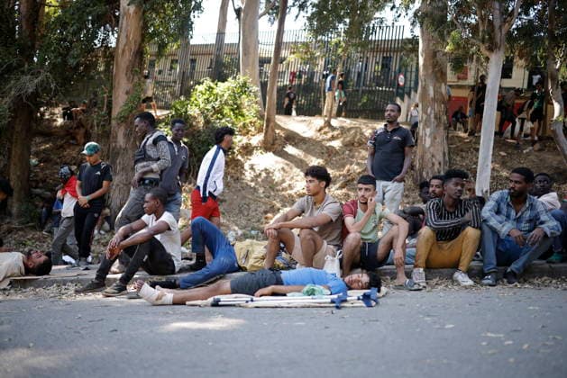 The barriers installed by the government in Ceuta are now fully operational. Several people are waiting at the gates of the Temporary Immigrant Shelter (CETI), on August 2, 2026, in Ceuta, Spain. The Tarajal border has remained calm despite a small group of people attempting to swim across; however, they were intercepted by the army. Although more than 48,000 migrants who had entered irregularly last Thursday have already left Ceuta, an unknown number of people who have refused to return remain in the city. AUGUST 2, 2026 PIXELATED MIGRATION CRISIS Jesú Ceuta, Ceuta, Spain  Copyright: xJesusxTorresx 7699316