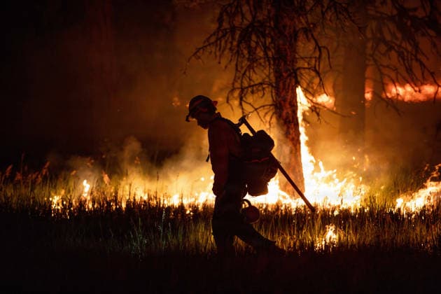 August 2, 2026, Prineville, Or, United States: A firefighter with the Oregon Department of Forestry is silhouetted by flames burning through a forested area along U.S. Highway 26 at the Rowe Creek Complex fire, July 27, 2026 near Prineville, Oregon. The lightning-caused fires including the Brewer, Green Mountain and Crosswhite fires combined into one and have burnt 3000,597 acres and is 57% contained. Prineville United States - ZUMAp138 20260802_zaa_p138_008 Copyright: xAndrewxAvitt UsxForestx