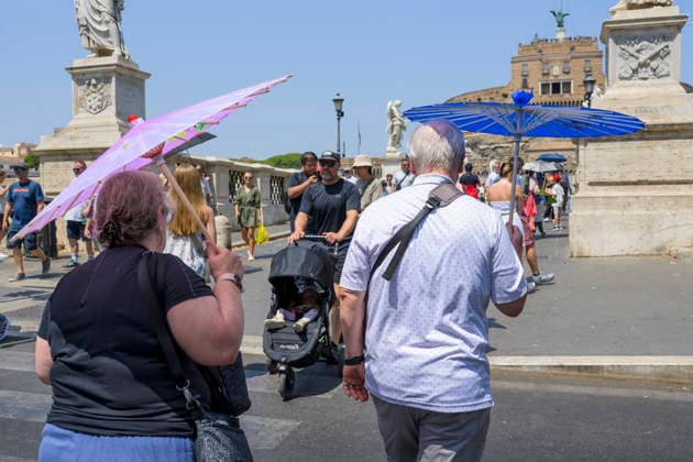 August 2, 2026, Rome, Italy: Two elderly tourists shield themselves from the sun s rays with two umbrellas on the first day of the fourth heat wave hitting Italy and Rome. Italy is facing the peak of the fourth severe heat wave of the summer, fueled by the persistent African anticyclone and record temperatures in the Mediterranean Sea, which are amplifying water and climate emergencies in the Po Valley and central Italy. Rome Italy  - ZUMAv147 20260802_zip_v147_007 Copyright: xMarcelloxValerix