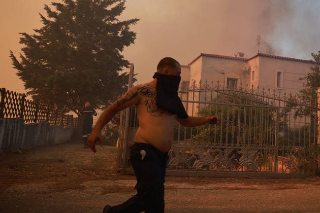 Firefighters battle wildfire in Greece s Viotia VIOTIA, GREECE - AUGUST 2: A man runs as a wildfire burns near Porto Germeno, 70 kilometres northwest of Athens, in the region of Viotia, Greece, on August 2, 2026. Costas Baltas Anadolu Athens Greece. Editorial use only. Please get in touch for any other usage.  Copyright: x2026xAnadoluxCostasxBaltasx