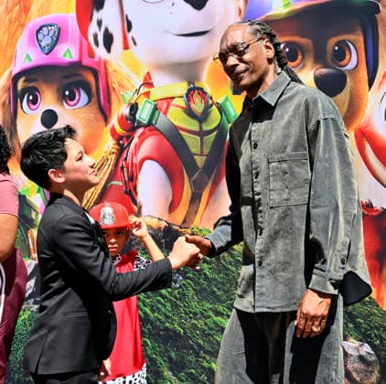 Cast members Rain Janjua and Snoop Dogg (R) attend the global premiere of the computer animated animal adventure Paw Patrol: The Dino Movie at the Paramount Picture Studio lot in Los Angeles on Sunday, August 2, 2026. Storyline: The Paw Patrol lands on a mysterious dinosaur island after a storm, where they meet Rex, a stranded pup. When Humdinger s reckless mining triggers a volcano, the team faces their biggest rescue mission yet to save the island.  LAP2026080230 JIMxRUYMEN