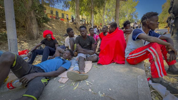 Migrant crisis in Cueta An unprecedented border crisis has hit the Spanish North African enclave of Ceuta, where an estimated 60,000 migrants crossed from Morocco. Pictured. African migrants resting on the street. 02.08.2026  Copyright: xIanxWhittakerx NINTCHDBPICT001099189158