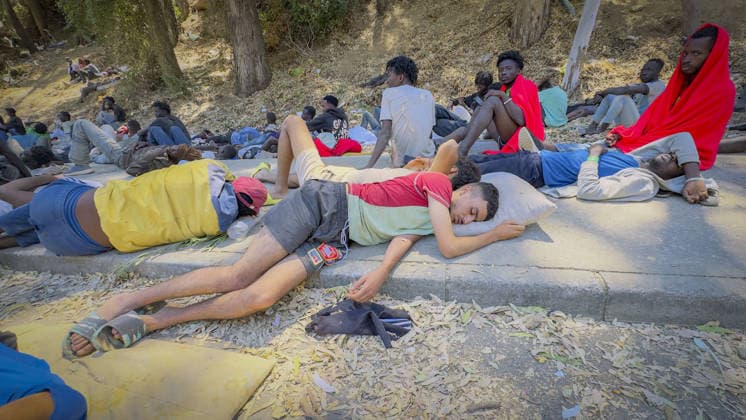 Migrant crisis in Cueta An unprecedented border crisis has hit the Spanish North African enclave of Ceuta, where an estimated 60,000 migrants crossed from Morocco. Pictured. African migrants resting on the street. 02.08.2026  Copyright: xIanxWhittakerx NINTCHDBPICT001099189207