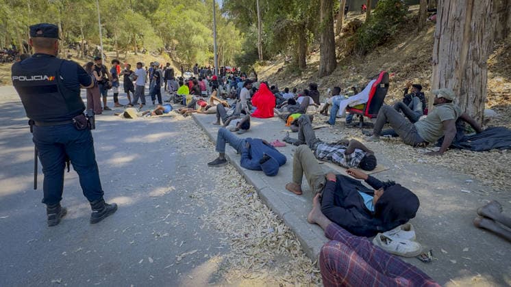 Migrant crisis in Cueta An unprecedented border crisis has hit the Spanish North African enclave of Ceuta, where an estimated 60,000 migrants crossed from Morocco. Pictured. African migrants resting on the street. 02.08.2026  Copyright: xIanxWhittakerx NINTCHDBPICT001099189210