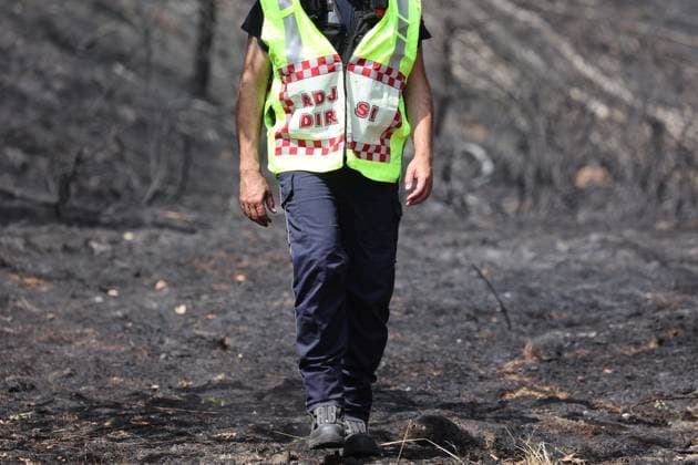Firefighters pictured at the scene of a brush fire along the E25 highway in Bastogne, on Monday 03 August 2026. A major brush fire broke out Monday morning in the municipality of Bastogne, near the Withimont highway rest area.  JULIENxWARNAND 182681994