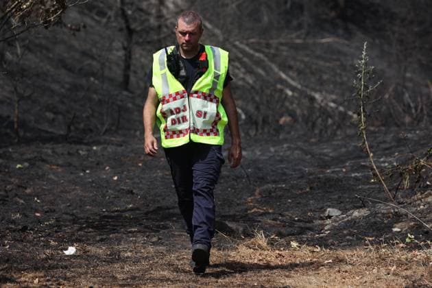 Firefighters pictured at the scene of a brush fire along the E25 highway in Bastogne, on Monday 03 August 2026. A major brush fire broke out Monday morning in the municipality of Bastogne, near the Withimont highway rest area.  JULIENxWARNAND 182681995