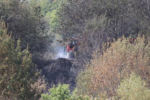 Firefighters pictured at the scene of a brush fire along the E25 highway in Bastogne, on Monday 03 August 2026. A major brush fire broke out Monday morning in the municipality of Bastogne, near the Withimont highway rest area.  JULIENxWARNAND 182682047