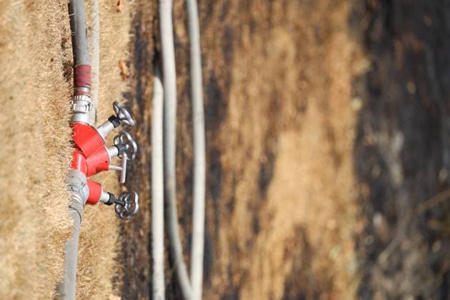 Fire hoses pictured at the scene of a brush fire along the E25 highway in Bastogne, on Monday 03 August 2026. A major brush fire broke out Monday morning in the municipality of Bastogne, near the Withimont highway rest area.  JULIENxWARNAND 182682048