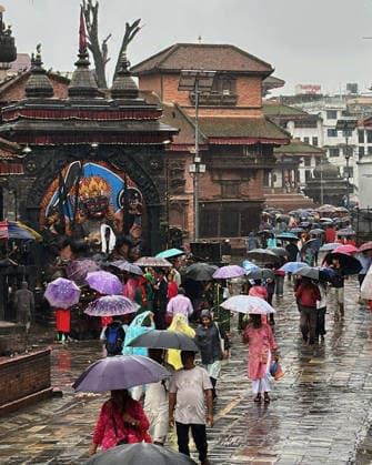 August 3, 2026, Kathmandu, Nepal: Devotees arrive under umbrellas to offer prayers during Shrawan Somvar at a Shiva temple in Kathmandu, Nepal on August 3, 2026. Mondays (Somvars) in the sacred month of Shrawan are considered especially auspicious for the worship of Lord Shiva. Devotees observe fasts and offer prayers seeking blessings, health, and prosperity. Many women keep the Shrawan Somvar fast for the long life and well-being of their husbands, while unmarried women pray for a virtuous and compatible life partner. Kathmandu Nepal  - ZUMAs233 20260803_zap_s233_002 Copyright: xSunilxSharmax