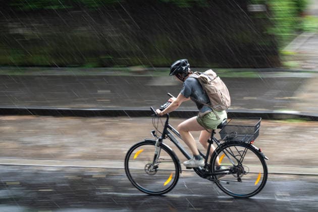 Starkregen in Göttingen 03.08.2026, Göttingen --- Eine Radfahrerin fährt während eines Starkregens durch eine Straße in Göttingen. Göttingen Niedersachsen Deutschland *** Heavy Rain in Göttingen, August 3, 2026; Göttingen: A cyclist rides down a street in Göttingen during a heavy rainstorm. Göttingen, Lower Saxony, Germany
