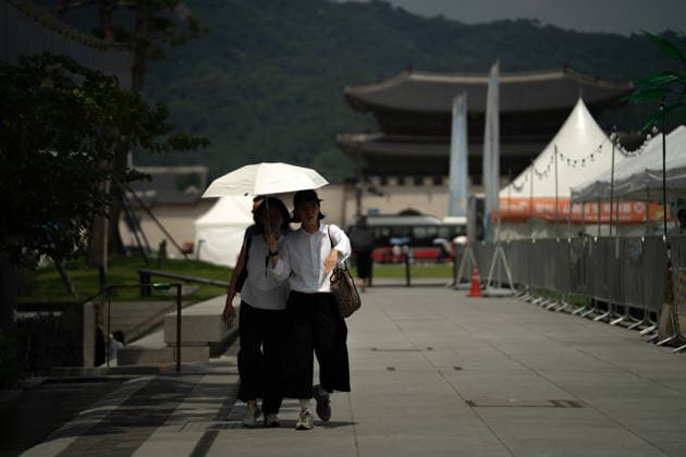Heat wave grips Seoul SEOUL, SOUTH KOREA - AUGUST 4: People walk holding umbrellas as a severe heat wave warning is declared amid a heat wave gripping Seoul, South Korea, on August 4, 2026. Hwawon Ceci Lee Anadolu Seoul South Korea. Editorial use only. Please get in touch for any other usage.  Copyright: x2026xAnadoluxHwawonxCecixLeex