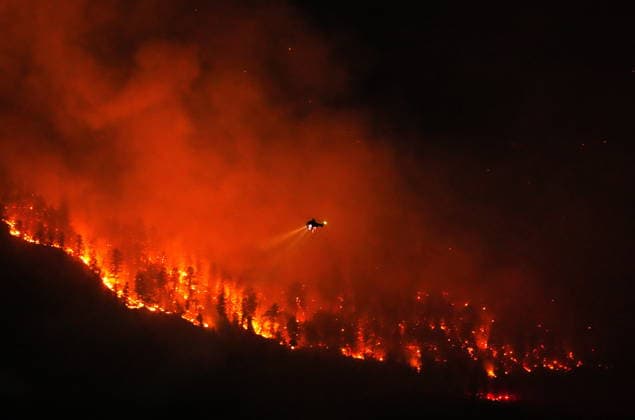 August 3, 2026, West Kelowna, Bc, CANADA: A helicopter conducting night operations prepares to drop water on the Quilpituk Creek wildfire burning on the west side of Okanagan Lake near Fintry, B.C., late Monday, August 3, 2026. West Kelowna CANADA  - ZUMAc35_ 20260803_zaf_c35_104 Copyright: xDarrylxDyckx