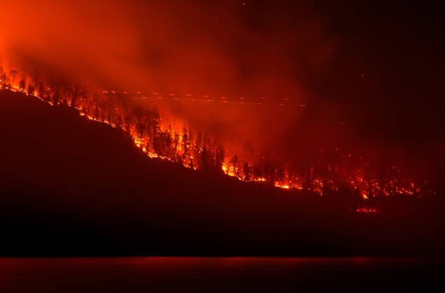 August 3, 2026, West Kelowna, Bc, CANADA: The Quilpituk Creek wildfire burns on the west side of Okanagan Lake as lights from a helicopter conducting night operations are seen near Fintry, B.C., late Monday, August 3, 2026. West Kelowna CANADA  - ZUMAc35_ 20260803_zaf_c35_119 Copyright: xDarrylxDyckx