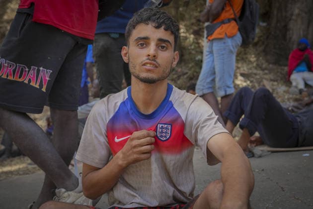 Migrant crisis in Cueta 03.08.2026. 03 08 26..An unprecedented border crisis has hit the Spanish North African enclave of Ceuta, where an estimated 60,000 migrants crossed from Morocco. Moroccan migrant teenager Abde Ellakkoh, 19, in his Jude Bellinghma England shirt outside the over crowded asylum centre in Ceuta  Copyright: xIanxWhittakerx NINTCHDBPICT001099242316