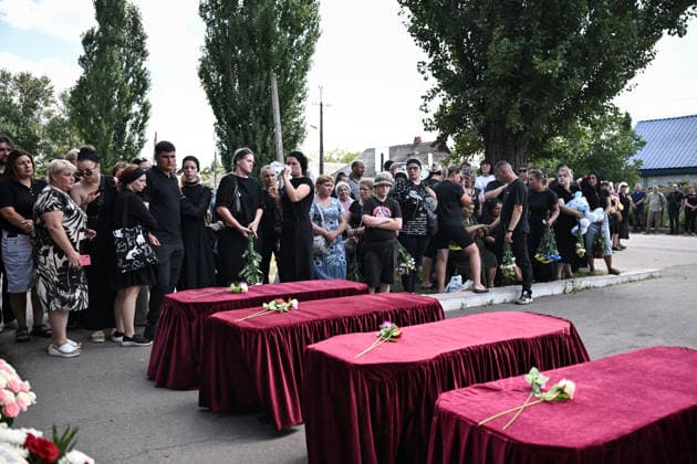 People pay their last respects to members of the Voronov family, killed when a Russian Iskander-M ballistic missile directly struck their home on the night of Thursday, July 30, Radushne settlement, Kryvyi Rih district, Dnipropetrovsk region, Ukraine, August 3, 2026. Five family members whose identities have been officially confirmed were laid to rest: parents Artem, 47, and Olena, 41, together with their children Mark, 17, Azarii Ilai, 11, and Emiliia, 6. Five other children who were in the house that night - Zakhar, Dominika, Viorika, Federika and one-and-a-half-year-old grandson Artem - are still officially listed as missing. Rescuers recovered 17 body fragments from the rubble, and complex forensic DNA examinations are under way to iden  Copyright: xDmytroxSmolienkox