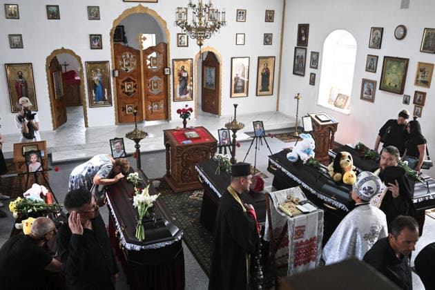 People pay their last respects to members of the Voronov family, killed when a Russian Iskander-M ballistic missile directly struck their home on the night of Thursday, July 30, during a funeral service in a church, Radushne settlement, Kryvyi Rih district, Dnipropetrovsk region, Ukraine, August 3, 2026. Five family members whose identities have been officially confirmed were laid to rest: parents Artem, 47, and Olena, 41, together with their children Mark, 17, Azarii Ilai, 11, and Emiliia, 6. Five other children who were in the house that night - Zakhar, Dominika, Viorika, Federika and one-and-a-half-year-old grandson Artem - are still officially listed as missing. Rescuers recovered 17 body fragments from the rubble, and complex forensic  Copyright: xDmytroxSmolienkox