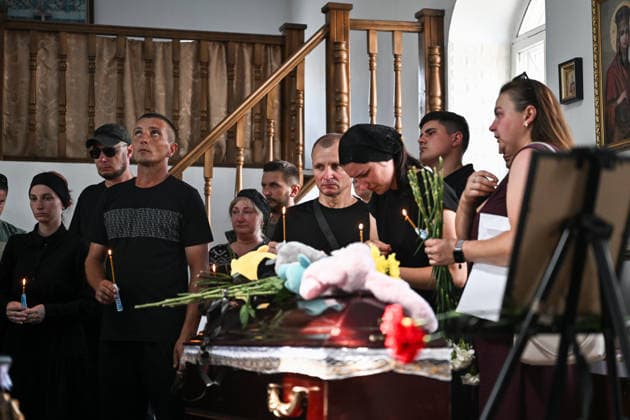 People pay their last respects to members of the Voronov family, killed when a Russian Iskander-M ballistic missile directly struck their home on the night of Thursday, July 30, during a funeral service in a church, Radushne settlement, Kryvyi Rih district, Dnipropetrovsk region, Ukraine, August 3, 2026. Five family members whose identities have been officially confirmed were laid to rest: parents Artem, 47, and Olena, 41, together with their children Mark, 17, Azarii Ilai, 11, and Emiliia, 6. Five other children who were in the house that night - Zakhar, Dominika, Viorika, Federika and one-and-a-half-year-old grandson Artem - are still officially listed as missing. Rescuers recovered 17 body fragments from the rubble, and complex forensic  Copyright: xDmytroxSmolienkox