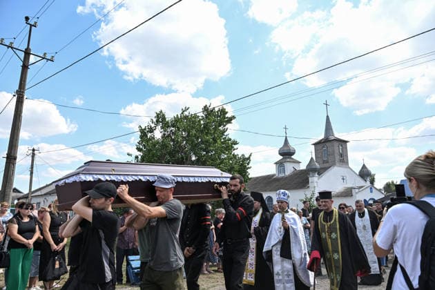 A funeral procession moves with coffins to a cemetery from a church after a service for members of the Voronov family, killed when a Russian Iskander-M ballistic missile directly struck their home on the night of Thursday, July 30, Radushne settlement, Kryvyi Rih district, Dnipropetrovsk region, Ukraine, August 3, 2026. Five family members whose identities have been officially confirmed were laid to rest: parents Artem, 47, and Olena, 41, together with their children Mark, 17, Azarii Ilai, 11, and Emiliia, 6. Five other children who were in the house that night - Zakhar, Dominika, Viorika, Federika and one-and-a-half-year-old grandson Artem - are still officially listed as missing. Rescuers recovered 17 body fragments from the rubble, and c  Copyright: xDmytroxSmolienkox