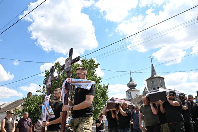 A funeral procession moves with coffins to a cemetery from a church after a service for members of the Voronov family, killed when a Russian Iskander-M ballistic missile directly struck their home on the night of Thursday, July 30, Radushne settlement, Kryvyi Rih district, Dnipropetrovsk region, Ukraine, August 3, 2026. Five family members whose identities have been officially confirmed were laid to rest: parents Artem, 47, and Olena, 41, together with their children Mark, 17, Azarii Ilai, 11, and Emiliia, 6. Five other children who were in the house that night - Zakhar, Dominika, Viorika, Federika and one-and-a-half-year-old grandson Artem - are still officially listed as missing. Rescuers recovered 17 body fragments from the rubble, and c  Copyright: xDmytroxSmolienkox