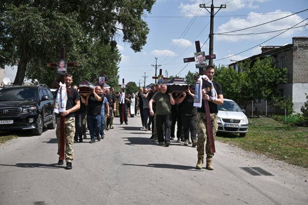 A funeral procession moves with coffins to a cemetery from a church after a service for members of the Voronov family, killed when a Russian Iskander-M ballistic missile directly struck their home on the night of Thursday, July 30, Radushne settlement, Kryvyi Rih district, Dnipropetrovsk region, Ukraine, August 3, 2026. Five family members whose identities have been officially confirmed were laid to rest: parents Artem, 47, and Olena, 41, together with their children Mark, 17, Azarii Ilai, 11, and Emiliia, 6. Five other children who were in the house that night - Zakhar, Dominika, Viorika, Federika and one-and-a-half-year-old grandson Artem - are still officially listed as missing. Rescuers recovered 17 body fragments from the rubble, and c  Copyright: xDmytroxSmolienkox
