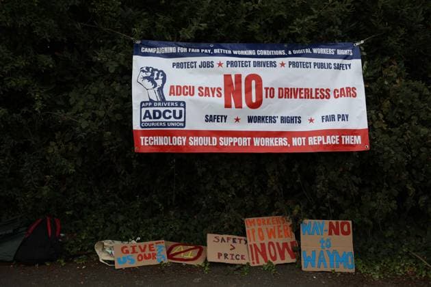 August 4, 2026, London, England, United Kingdom: Members of the App Drivers & Couriers Union (ADCU), Brent Green Party and the Pull the Plug on Waymo campaign attend a protest outside WAYMO s offices in Park Royal, London, opposing the expansion of autonomous vehicles. Demonstrators argued that driverless technology threatens drivers job security and livelihoods and called for greater protections for workers rights. London United Kingdom  - ZUMAa279 20260804_zsp_a279_007 Copyright: xZeynepxDemirxAslimx