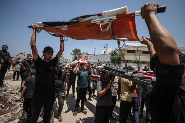 Palestinians mourn 112 people retrieved from rubble in Gaza GAZA, PALESTINE - AUGUST 04: Palestinians carry coffins during a mass funeral ceremony in Gaza, Palestine, on August 04, 2026. The bodies of 112 Palestinians, who were killed in Israeli attacks targeting the area where the Hasayine and Abu Sharia families lived in the Sabra neighborhood of Gaza City in November 2023 and were recovered from under the rubble nearly three years later, are laid to rest during the ceremony. Ali Jadallah Anadolu Gaza Palestine. Editorial use only. Please get in touch for any other usage.  Copyright: x2026xAnadoluxAlixJadallahx