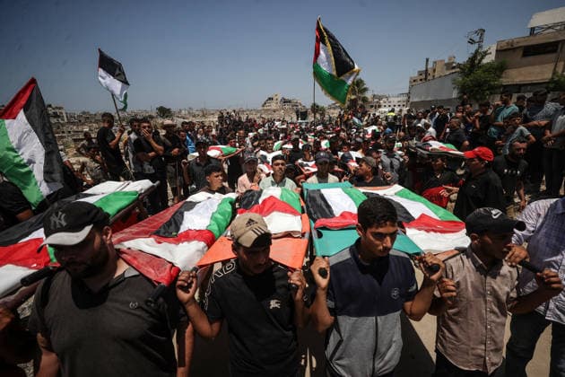 Palestinians mourn 112 people retrieved from rubble in Gaza GAZA, PALESTINE - AUGUST 04: Palestinians carry coffins during a mass funeral ceremony in Gaza, Palestine, on August 04, 2026. The bodies of 112 Palestinians, who were killed in Israeli attacks targeting the area where the Hasayine and Abu Sharia families lived in the Sabra neighborhood of Gaza City in November 2023 and were recovered from under the rubble nearly three years later, are laid to rest during the ceremony. Ali Jadallah Anadolu Gaza Palestine. Editorial use only. Please get in touch for any other usage.  Copyright: x2026xAnadoluxAlixJadallahx