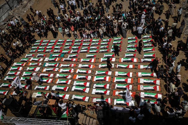 Palestinians mourn 112 people retrieved from rubble in Gaza GAZA, PALESTINE - AUGUST 04: An aerial view of Palestinians taking part in a funeral for 112 Palestinians in Gaza, Palestine, on August 04, 2026. The 112 Palestinians were killed in Israeli attacks targeting the area where the Hasayine and Abu Sharia families lived in the Sabra neighborhood of Gaza City in November 2023, and their bodies were retrieved from the rubble nearly three years later. Ali Jadallah Anadolu Gaza Palestine. Editorial use only. Please get in touch for any other usage.  Copyright: x2026xAnadoluxAlixJadallahx