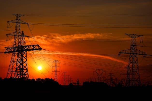 (260803) -- BUDAPEST, Aug. 3, 2026 -- Power transmission facilities are seen from the banks of the Danube River near Dunaszentbenedek, Hungary, Aug. 2, 2026. Hungary is entering its most critical 5 days as dropping water levels on the Danube River threaten the complete shutdown of the Paks nuclear power plant amid an extreme heatwave, Hungary s Prime Minister Peter Magyar said on Sunday, warning that the plant could be shut down for more than a month. (Photo by Xinhua) HUNGARY-NUCLEAR POWER PLANT-POSSIBLE SHUTDOWN DavidxBalogh 
