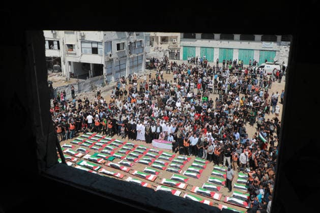 Palestinians Hold Mass Funeral For 112 Family Members In Gaza - Palestine A photograph shows the flag-covered remains of members of the Abu Sharia and al-Hasayna families, recently recovered from the rubble of residential buildings in the al-Sabra neighbourhood which were struck by Israeli bombardments in November 2023, during a mass funeral in Gaza City on August 4, 2026. An October ceasefire remains in place between Israel and Hamas, but it has not halted the violence in Gaza. Photo by Photo by Rizek ELdremle ABACAPRESS.COM Gaza City Palestine  Copyright: xEldremlexRizek ABACAx